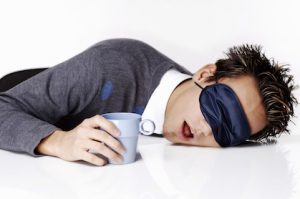 exhausted-man-sleeping-with-head-on-desk
